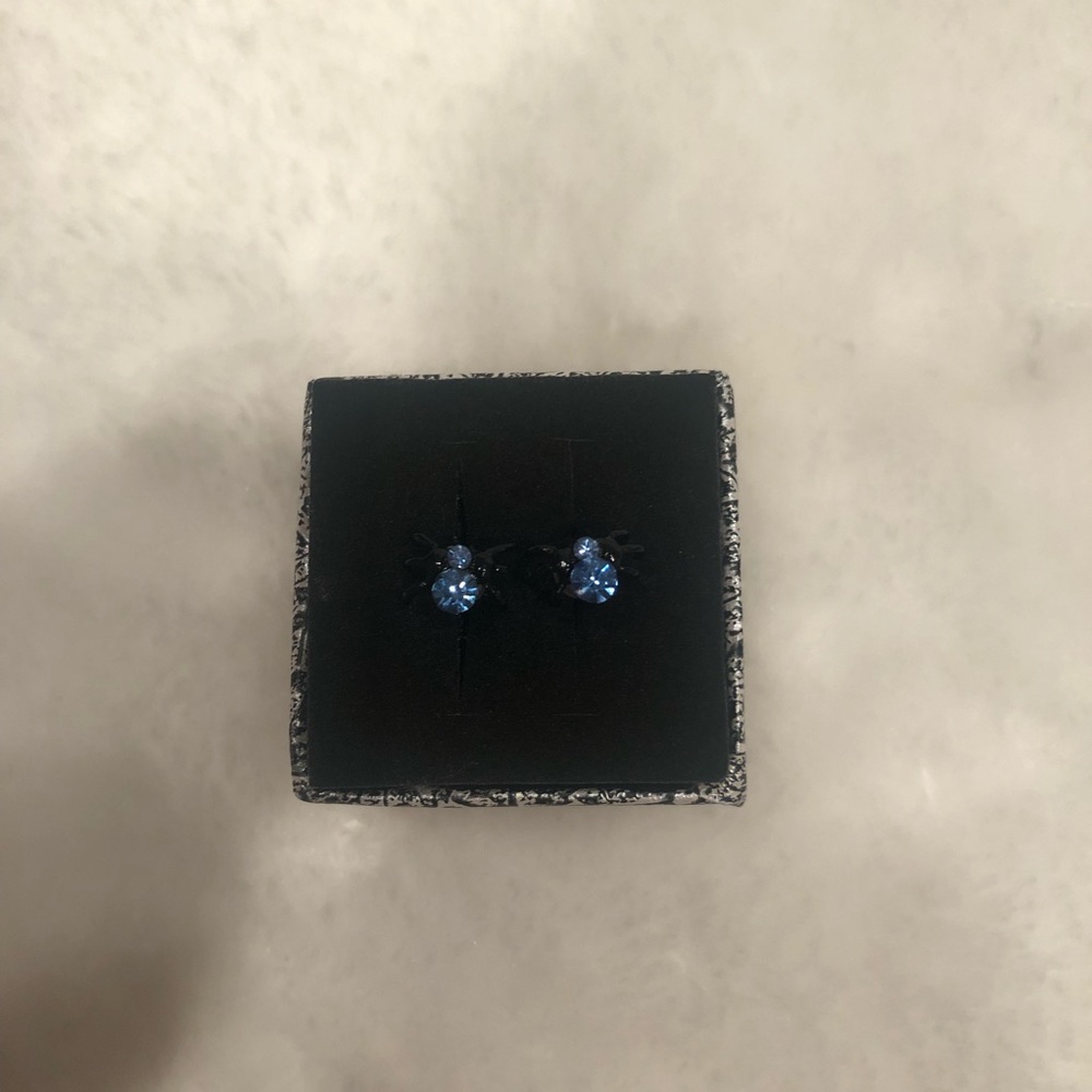 Gorgeous spider earrings with light blue gem.